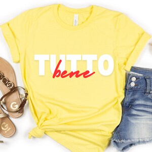 May include: Yellow t-shirt with the text "TUTTO bene" in white and red lettering.