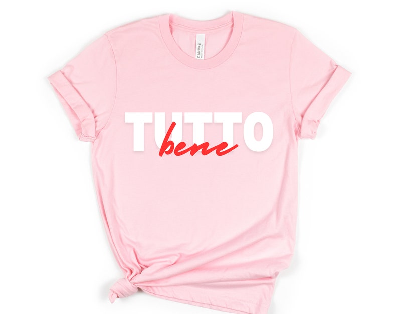 May include: Pink t-shirt with the text "TUTTO bene" in white and red lettering.
