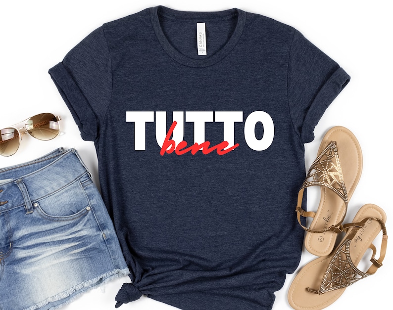 May include: A navy blue t-shirt with the text "TUTTO bene" in white and red lettering.