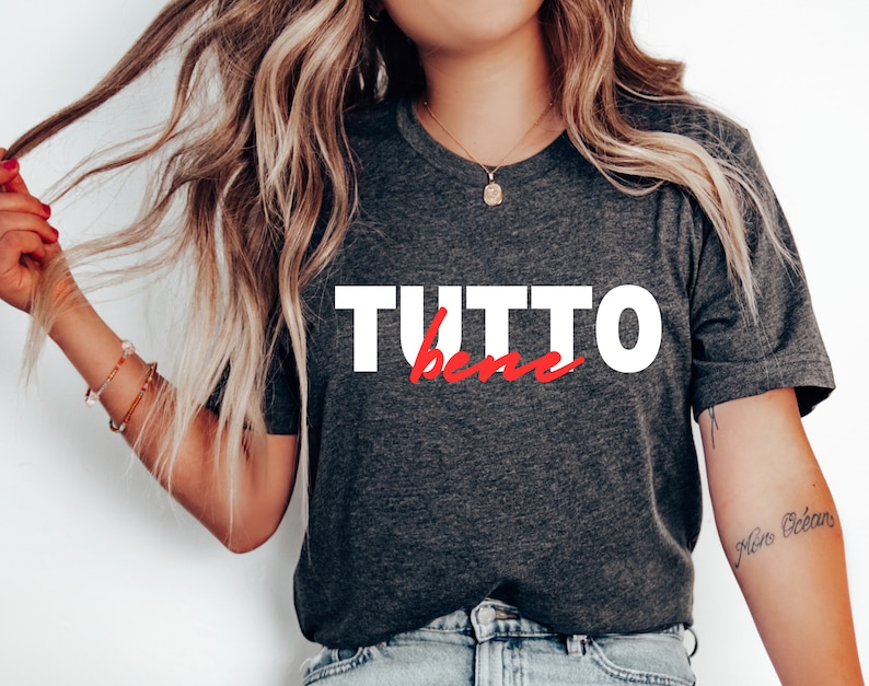 May include: A dark gray t-shirt with the text "TUTTO bene" in white and red lettering.