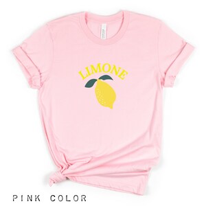 May include: Pink t-shirt with a yellow lemon graphic and the word "LIMONE" in yellow letters.