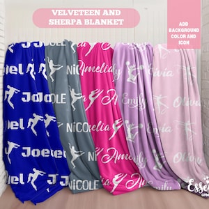 May include: Four personalized fleece blankets with white text and silhouettes of dancers. The blankets are blue, gray, pink, and purple. The text on the blankets reads "JoJo", "Nicole", "Amelia", and "Olivia".