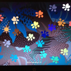 May include: A colorful abstract design with a variety of paw prints in different colors and sizes. The background is a dark gray with blue and green leaves and other abstract shapes. The text "&copy;2020 Paula Navarro, LPC" is at the bottom of the image.