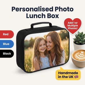 May include: A black rectangular lunch box featuring a custom photo print of a smiling child and adult on the front panel. The product includes a top handle and zipper closure. Text on the image reads: Personalised Photo Lunch Box, Add 1 or Multiple Photos!, Red, Blue, Black, and Handmade in the UK.