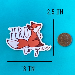 May include: A white sticker with a cartoon fox and the text "zero to give" in brown lettering. The sticker is 3 inches wide and 2.5 inches tall.