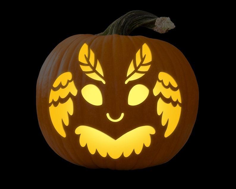 May include: A carved pumpkin with a glowing face of a creature with wings and leaves. The creature has large eyes, a small mouth, and a fluffy collar.