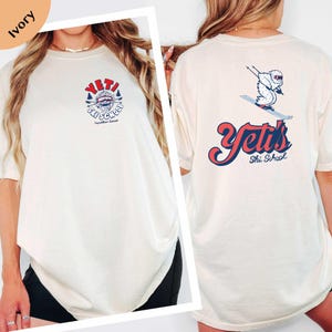 A woman wearing a white t-shirt with a graphic design on the front and back.