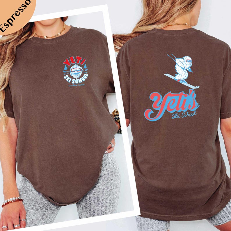 a woman wearing a brown t-shirt with a graphic design on the back.