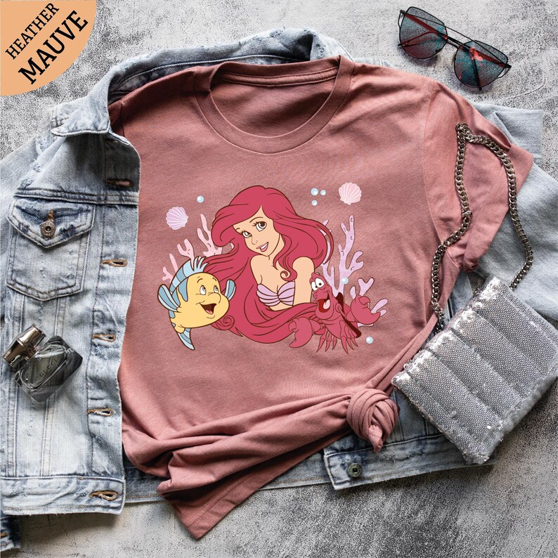 a pink shirt with a little mermaid on it