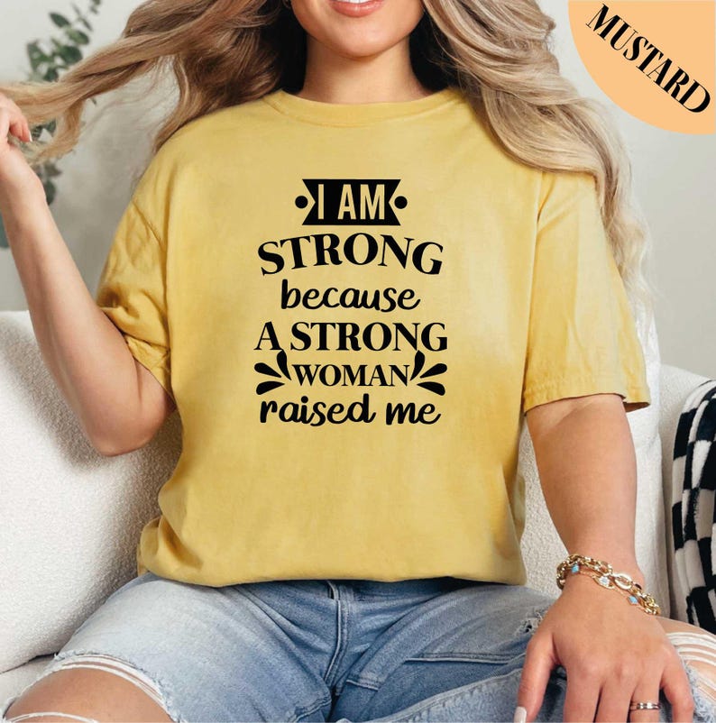 a woman wearing a t - shirt that says i am strong because a strong woman