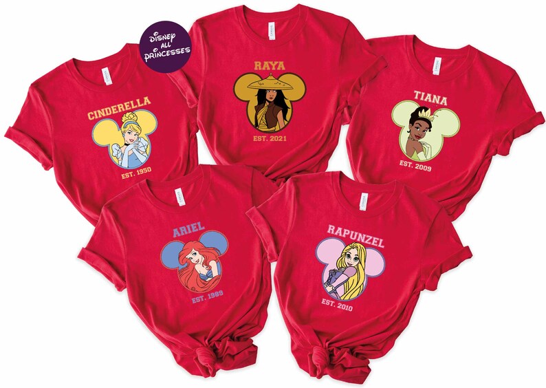 A collection of red t-shirts featuring Disney princesses, including Cinderella, Ariel, Rapunzel, and Tiana.