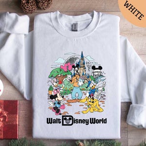 a white shirt with mickey mouse and friends on it