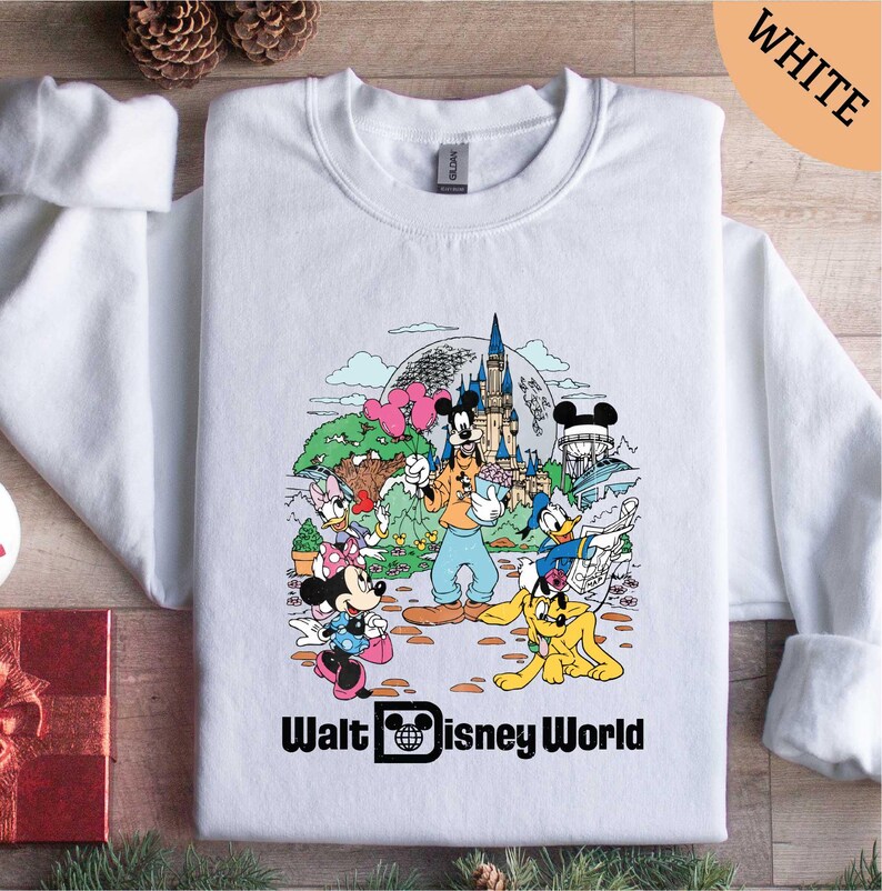 a white shirt with mickey mouse and friends on it