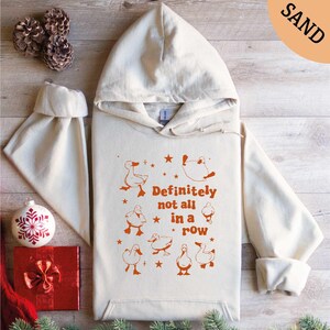 a white hoodie with an orange print on it