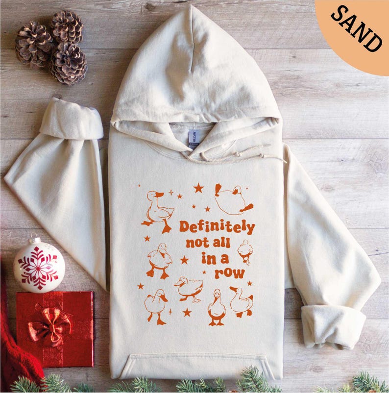 a white hoodie with an orange print on it