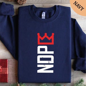 a navy sweatshirt with a crown on it