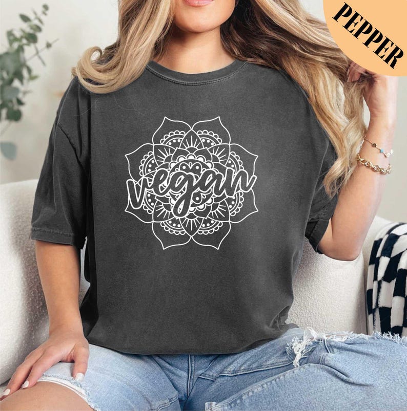 a woman sitting on a couch wearing a black crop top