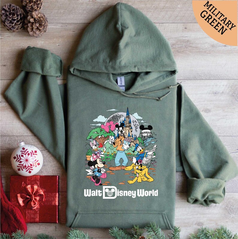 a green hoodie with a picture of disney world on it