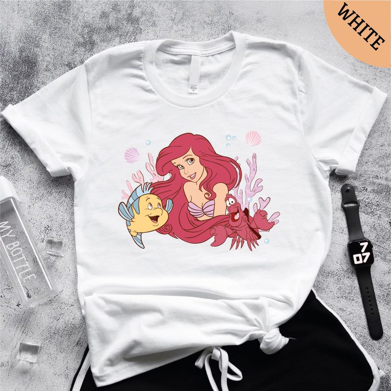 a t - shirt with an image of a mermaid and a fish on it