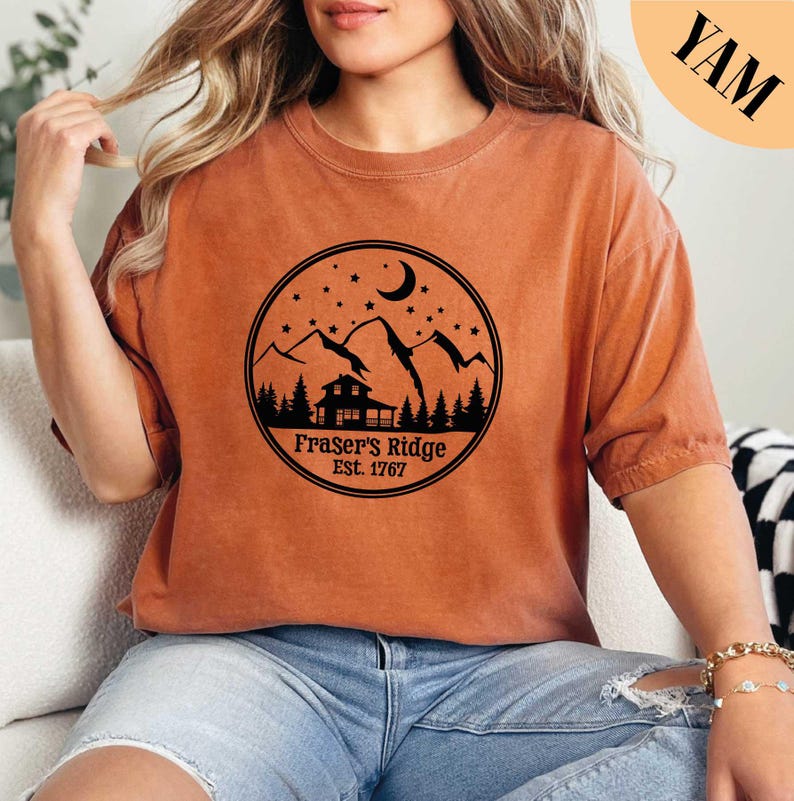 a woman sitting on a couch wearing a brown shirt