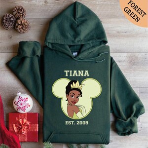 a green hoodie with a picture of a princess on it