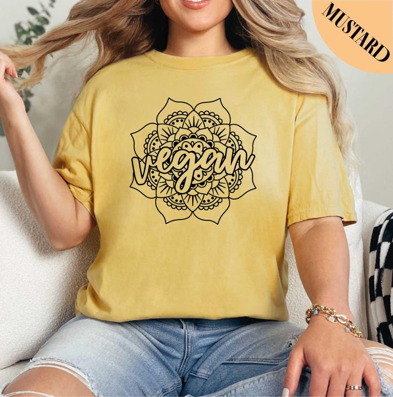 a woman sitting on a couch wearing a yellow shirt
