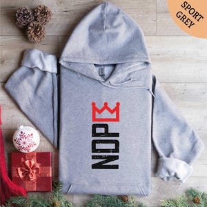 a gray hoodie with a crown on it