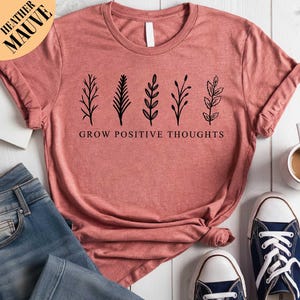 a t - shirt that says grow positive thoughts