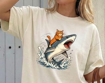 Comfort Colors® Cat Bite Shark T-Shirt, Cat Riding Shark Shirt, Ocean Sweater, Animal Lover Shirt, Cat Mom Sweatshirt, Funny Cat T-Shirt