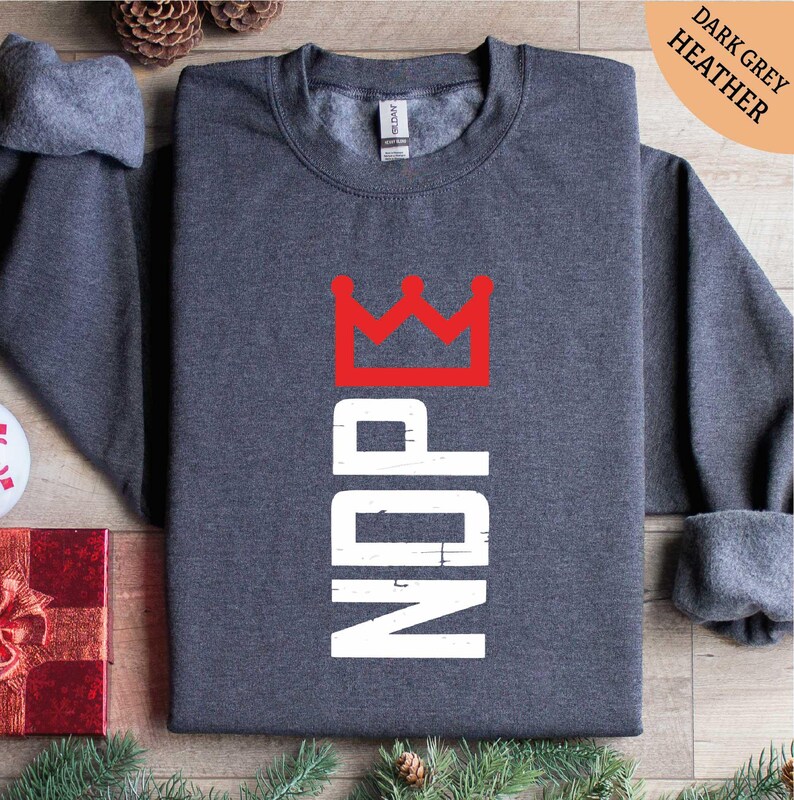 a gray shirt with a red crown on it