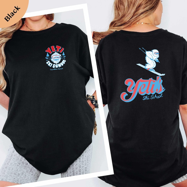 a woman wearing a black t-shirt with a graphic design on the back.