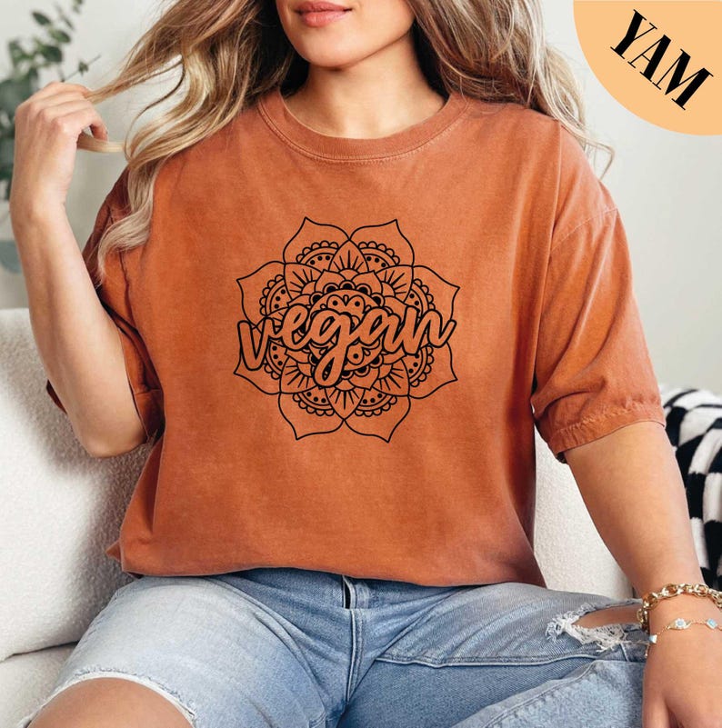 a woman sitting on a couch wearing a brown shirt