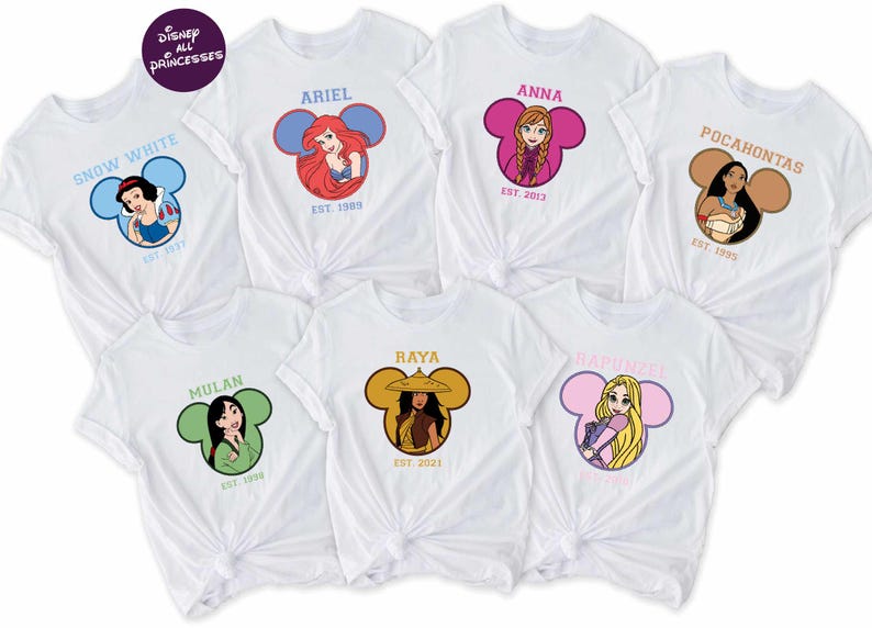 a collection of white t-shirts featuring Disney princesses, including Snow White, Ariel, Pocahontas, Mulan, Baya, Rapunzel, and Rapunzel.