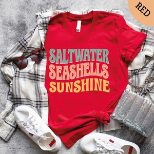 a red shirt that says saltwater seashells sunshine