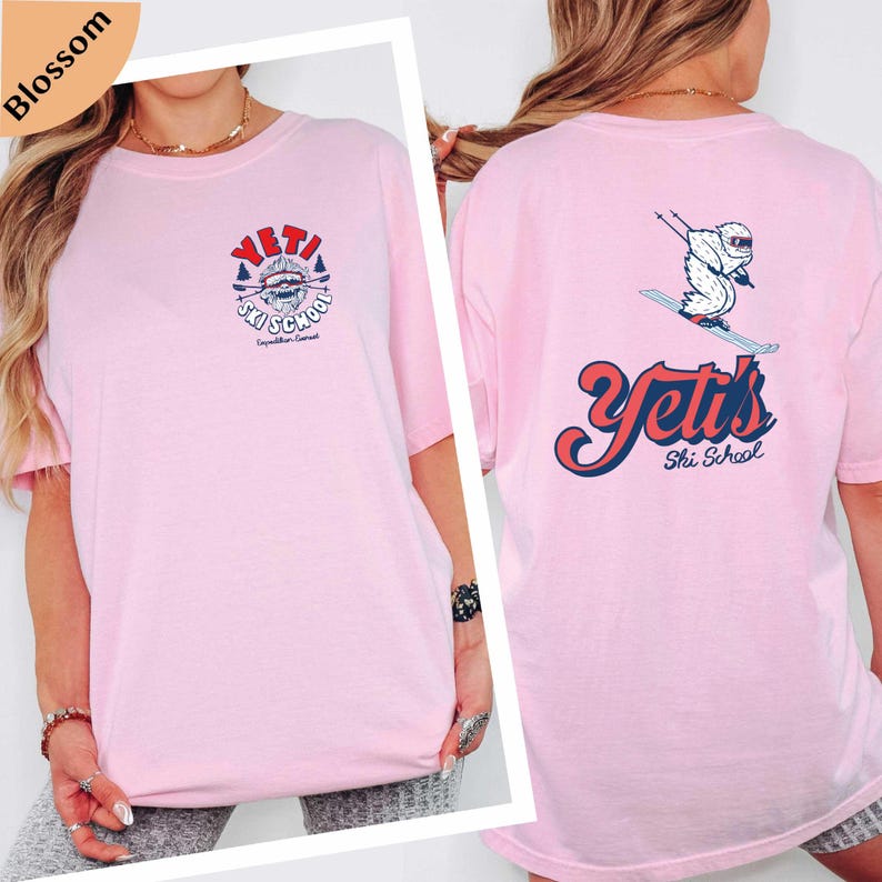 A woman wearing a pink t-shirt with a graphic design and text on the back.