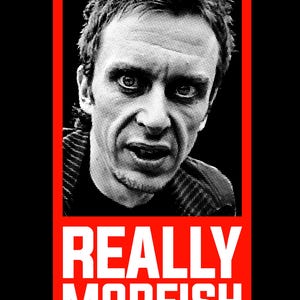 May include: Black and white halftone portrait of a man with the words "REALLY MOREISH" in white block letters on a red rectangle. The Vanity Publishing logo is in the bottom right corner.