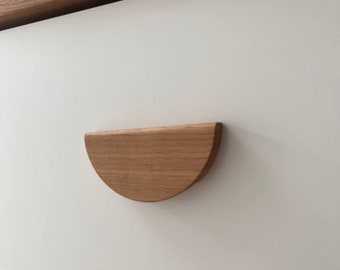 May include: A white dresser drawer with a half-circle wooden handle.