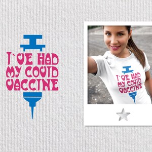 May include: A white t-shirt with a blue and pink graphic of a syringe with the text "I've had my covid vaccine".