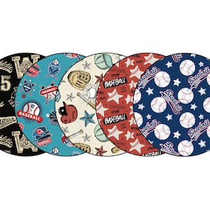 May include: Four round fabric coasters with baseball-themed designs. The coasters feature different patterns, including baseballs, stars, bats, and gloves. The text "Baseball" appears on each coaster.