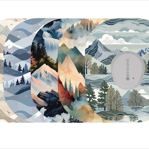 May include: A set of five oval-shaped medical device covers featuring watercolor landscape designs. The designs include mountains, forests, and waterfalls in shades of blue, beige, and green. One cover has a gray device with the text "dexcom".