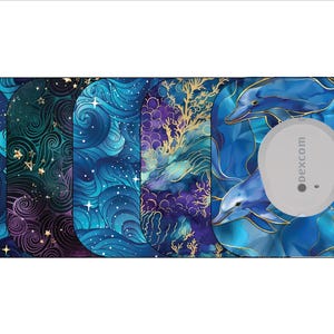 May include: A collection of decorative covers for a medical device, featuring various artistic designs. The designs include swirling blue and teal patterns with stars, and a dolphin motif. The device itself is a small, round, gray sensor.