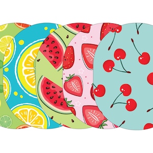 May include: Five round coasters with different fruit designs. The coasters are green, blue, pink, and light blue with various fruits like lemons, limes, strawberries, cherries, and watermelon.