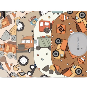 May include: Four different designs of adhesive stickers for a Dexcom continuous glucose monitor. The designs feature a brown background with illustrations of construction vehicles, including dump trucks, bulldozers, and excavators. The text "DIG DIG DIG" appears on one of the designs.