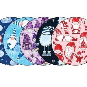 May include: Five round fabric coasters with different gnome patterns. Each coaster features a different color background and gnome design. The coasters are perfect for adding a festive touch to your home decor.