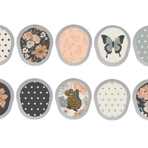 May include: Ten round, decorative stickers with various patterns. The patterns include polka dots, butterflies, and floral designs in shades of pink, green, black, and white.