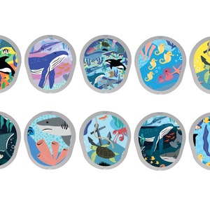 May include: Ten colorful round illustrations of various sea creatures and plants. Each illustration is set against a blue background and surrounded by a gray circle. The illustrations include a whale, a shark, a stingray, a sea turtle, a jellyfish, a seahorse, a crab, seaweed, and coral.