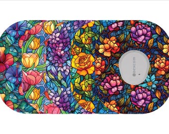 May include: A floral patterned medical device overlay featuring a stained glass design with red, yellow, purple, and blue flowers. The device has a gray circular component with the text "dexcom".