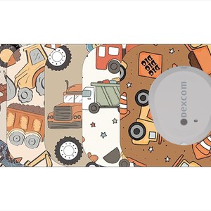 May include: A Dexcom sensor overlay featuring a construction theme. The design includes illustrations of trucks, tractors, and the word "DIG" on a brown background. The overlay is designed to fit a Dexcom sensor.