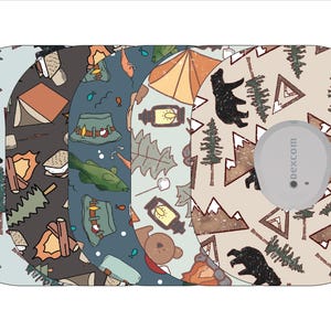 May include: Three different designs for a Dexcom G6 CGM device skin. The designs feature a camping theme with bears, mountains, trees, and tents. The designs are in shades of brown, blue, and beige.
