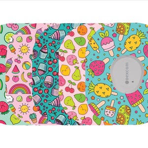 May include: A collection of patterned medical device covers featuring colorful cartoon fruits, desserts, and rainbows. The designs include strawberries, cherries, cupcakes, and ice pops. A gray circular device with the text "dexcom" is visible.